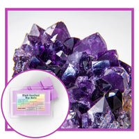 Amethyst crystal cluster with a box of Black Amethyst Wax Melts on a white background