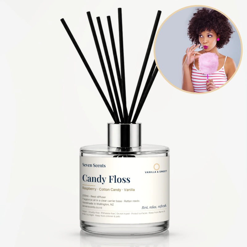 Candy Floss Reed Diffuser by Seven Scents - glass bottle with a woman holding pink candy floss