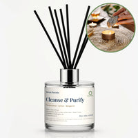Cleanse & Purify Reed Diffuser by Seven Scents - glass bottle with a sage bundle and candles on a woven mat