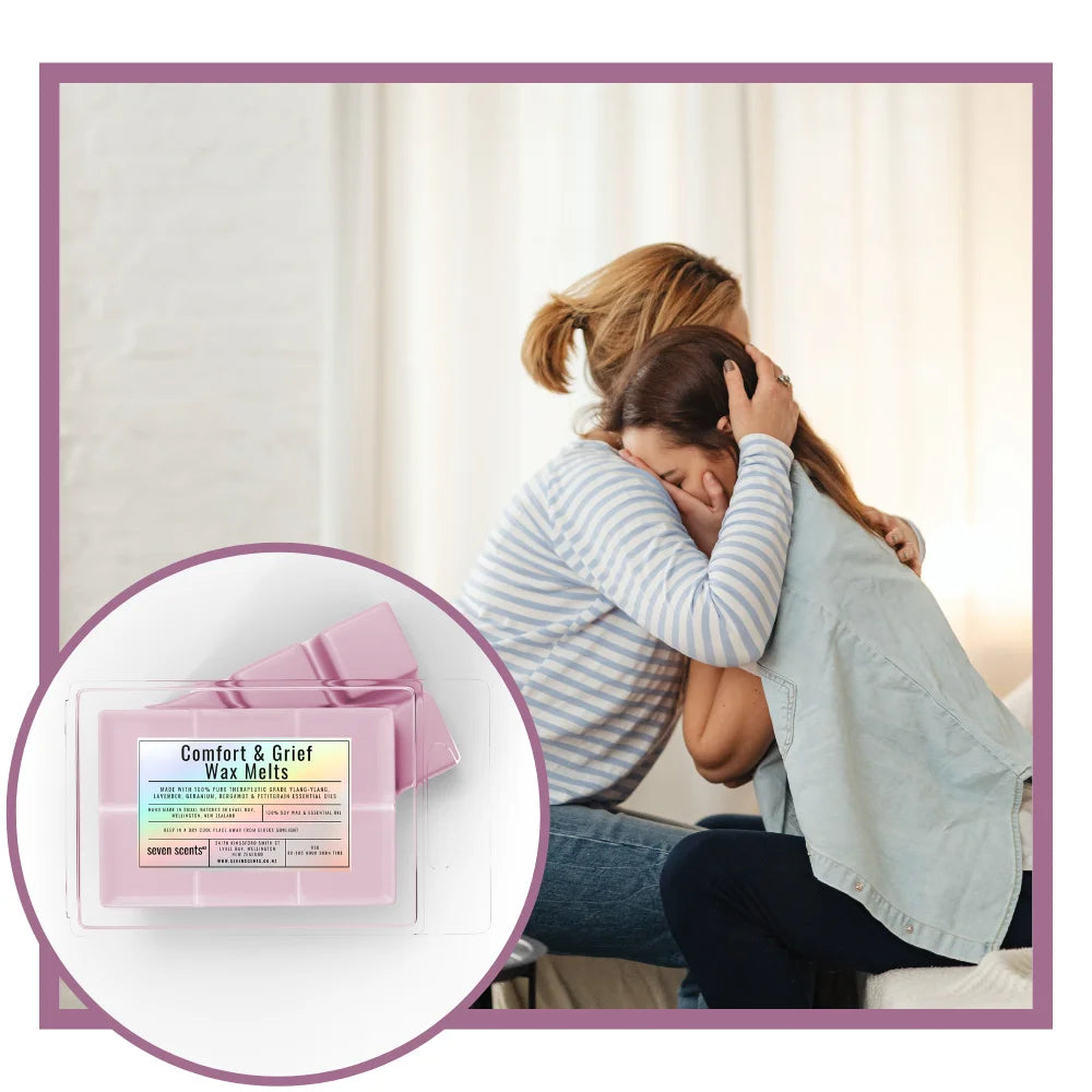 Two women hugging with a product inset labeled 'Comfort & Grief Wax Melts' on a light background.