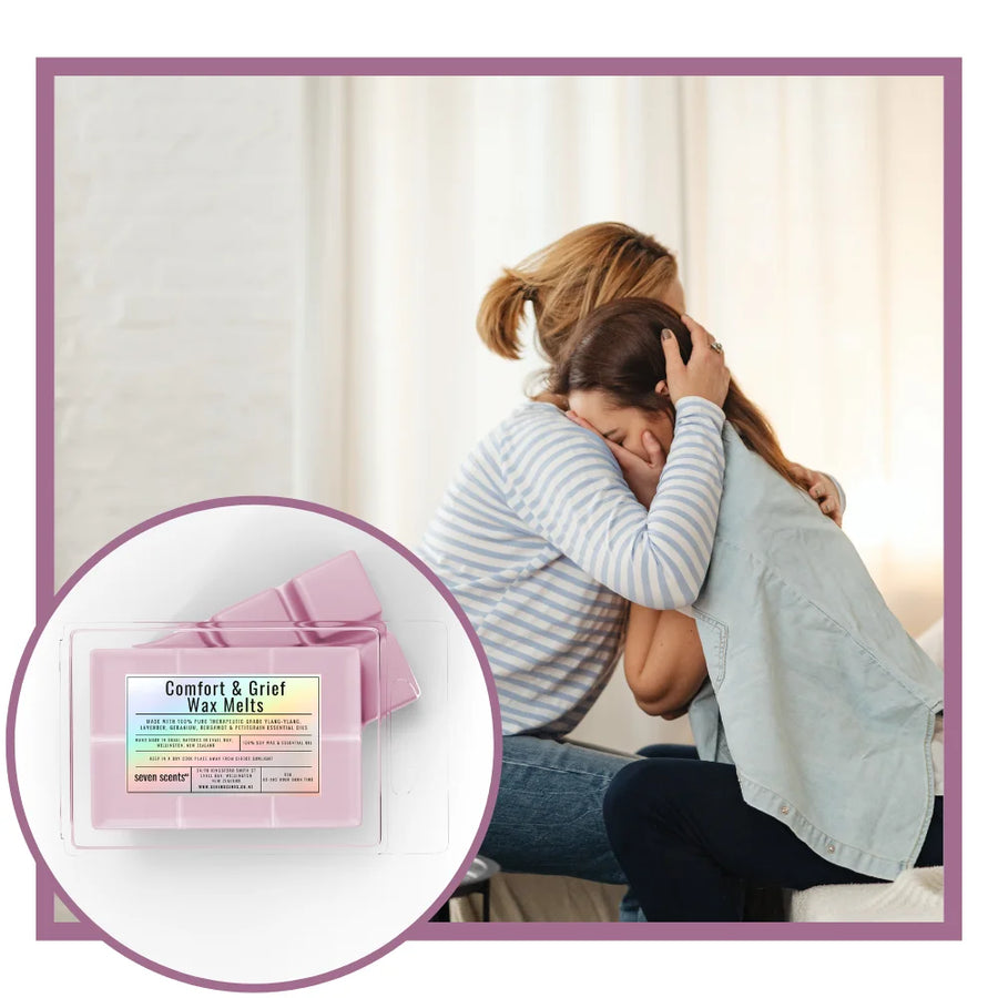 Two women hugging with a product inset labeled 'Comfort & Grief Wax Melts' on a light background.