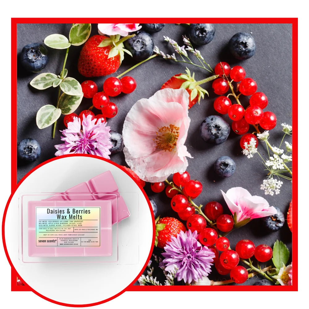 Daisies & Berries wax melts packaging with strawberries, blueberries, and flowers on a dark surface