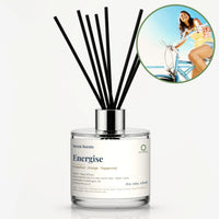Energise Reed Diffuser by Seven Scents - glass bottle with a woman riding a bike in the sun