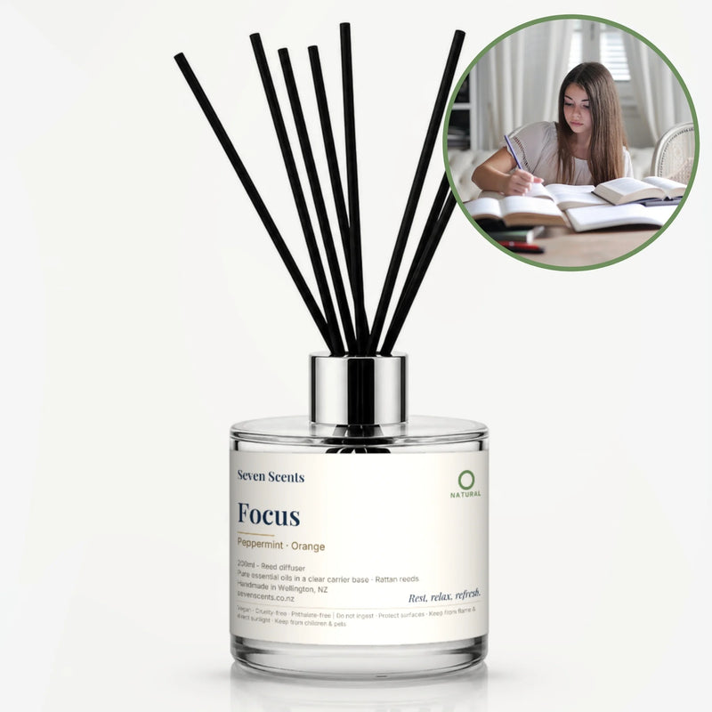 Focus Reed Diffuser by Seven Scents - glass bottle with a young woman studying with open books