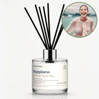 Happiness Reed Diffuser by Seven Scents - glass bottle with a woman laughing by the water