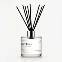 Juicy Peach Reed Diffuser by Seven Scents - 200ml clear glass bottle with black reeds and a silver collar