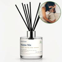 Mama Mia Reed Diffuser by Seven Scents - glass bottle with a mother lying beside her newborn baby