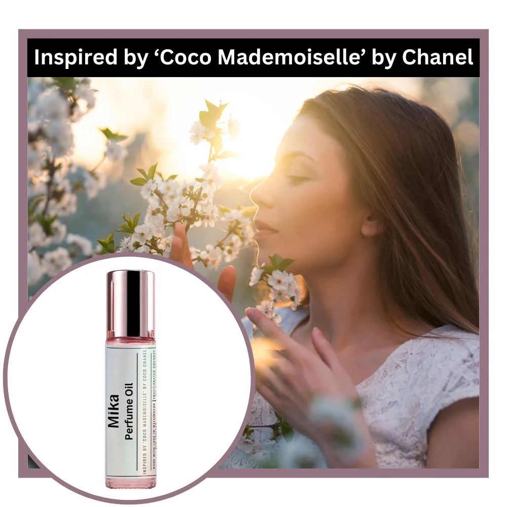 Mika perfume oil inspired by Coco Mademoiselle by Chanel with a woman smelling flowers at sunset