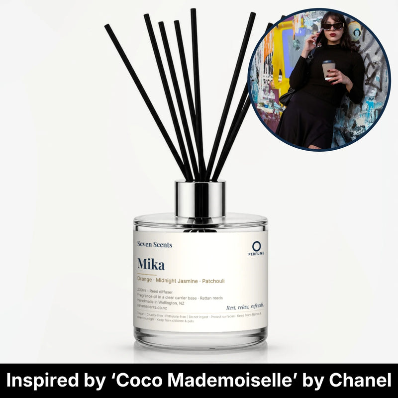 Mika Reed Diffuser by Seven Scents - glass bottle with a woman in black sunglasses holding a coffee