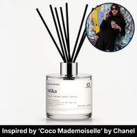 Mika Reed Diffuser by Seven Scents - glass bottle with a woman in black sunglasses holding a coffee