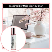 Miss feminine perfume oil bottle inspired by Miss Dior by Dior with a desk and flowers.
