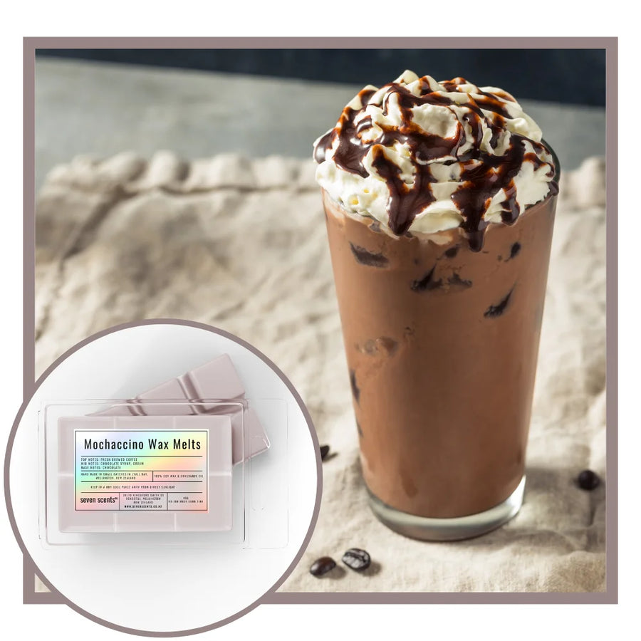 Chocolate mochaccino drink with whipped cream and a package of MochaCino Wax Melts on a textured surface.