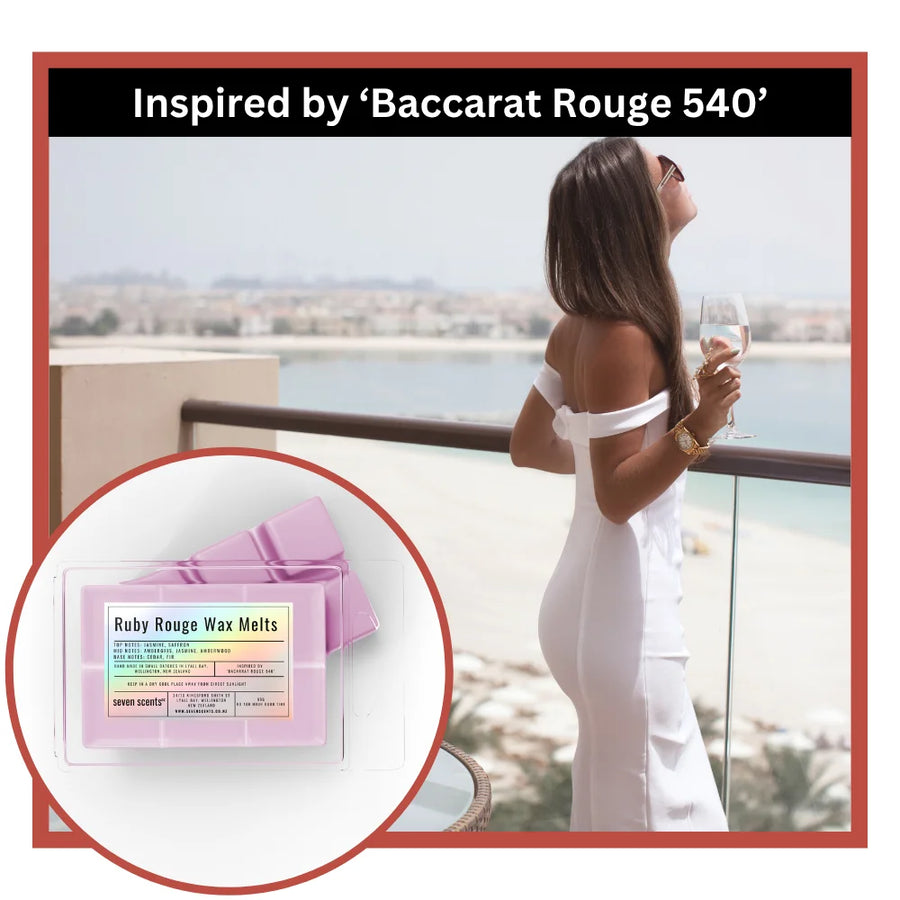Woman in white dress on balcony with inset of Ruby Rouge wax melts packaging.