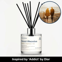 Sweet Obsession Reed Diffuser by Seven Scents - glass bottle with a couple walking on a beach at sunset