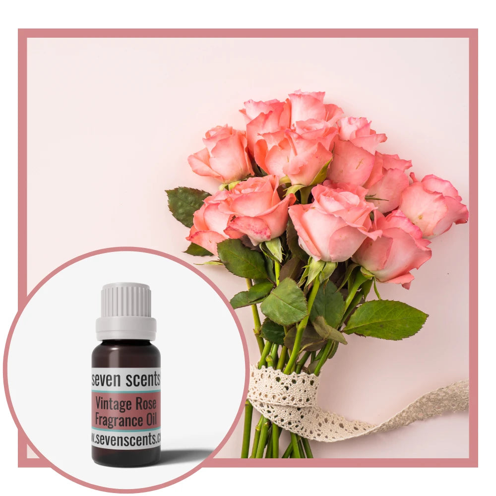 Bouquet of pink roses with a Seven Scents vintage rose fragrance oil bottle on a light pink background