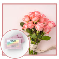 Bouquet of pink roses with a box of 'Vintage Rose Wax Melts' on a light pink background