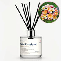 Wild Frangipani Reed Diffuser by Seven Scents - glass bottle with pink and yellow frangipani flowers